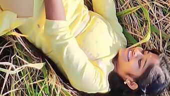 A Lovely Girl In A Yellow Outfit Engages In Sexual Activities In A Field With A Well-Endowed Partner